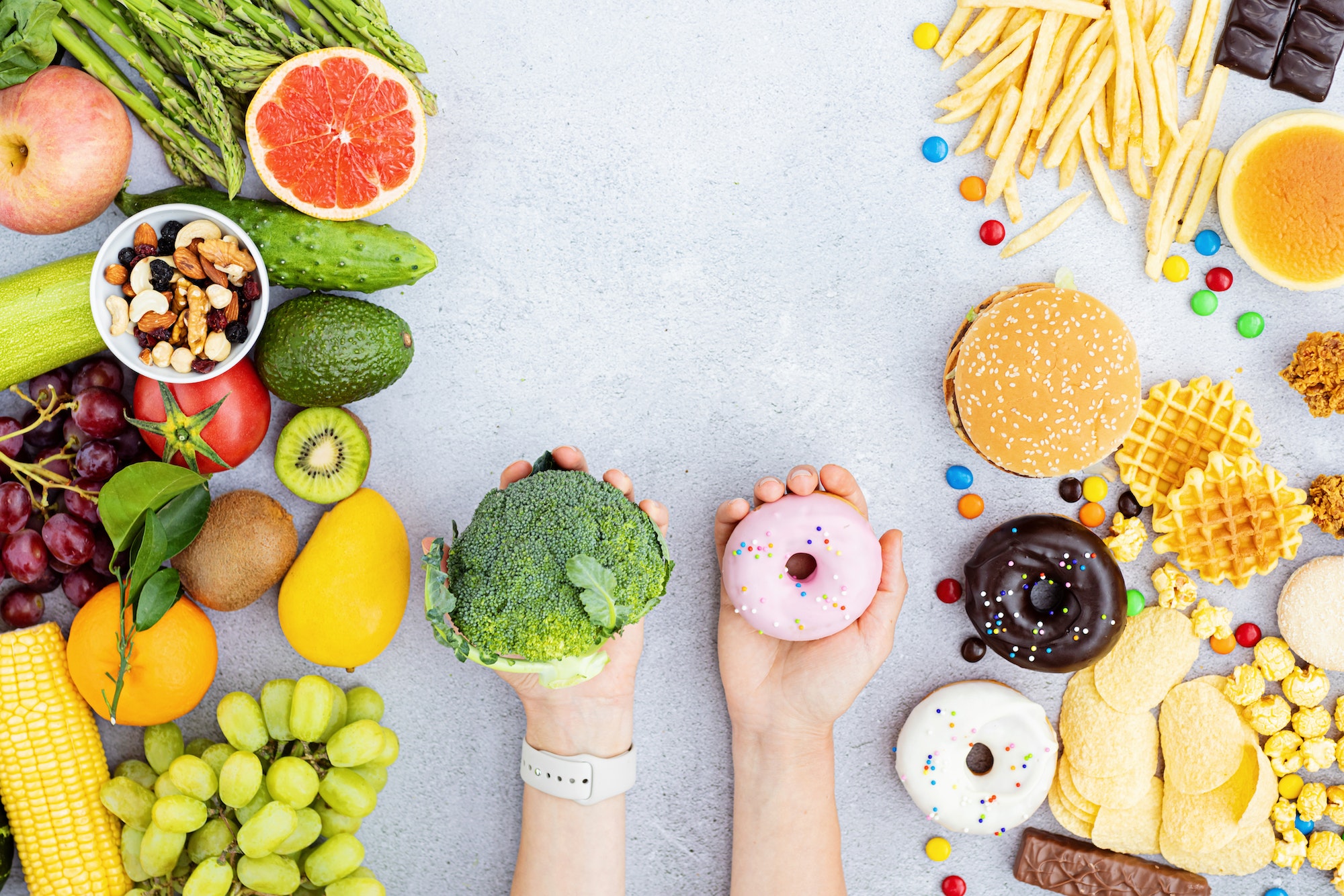 Flat lay of Healthy and unhealthy food from fruits and vegetables vs fast food, sweets and pastry